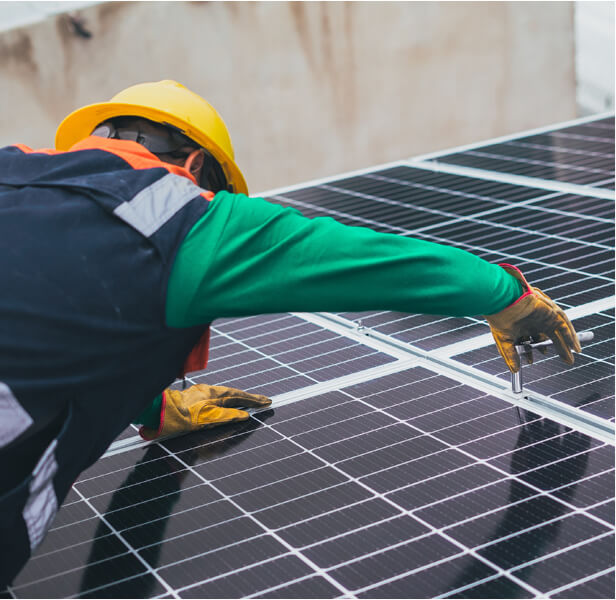 worker fixing solar panels