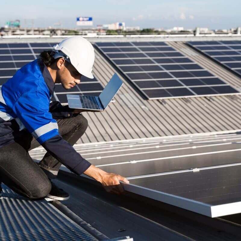 Asian technician installing inspection or repair solar cell panels solar cells on roof top factory